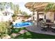 Inviting backyard with a sparkling pool, covered patio, and lush landscaping at 968 W Breckenridge Ave, Gilbert, AZ 85233