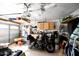Organized garage with ceiling storage and a motorcycle at 968 W Breckenridge Ave, Gilbert, AZ 85233