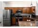 Updated kitchen features stainless steel appliances, light wood cabinets, and granite countertops at 968 W Breckenridge Ave, Gilbert, AZ 85233