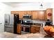 Updated kitchen features stainless steel appliances, light wood cabinets, and granite countertops at 968 W Breckenridge Ave, Gilbert, AZ 85233
