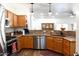 Updated kitchen features stainless steel appliances, light wood cabinets, and granite countertops at 968 W Breckenridge Ave, Gilbert, AZ 85233