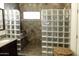 Beautiful tiled shower with glass block wall and seat with tiled floor at 968 W Breckenridge Ave, Gilbert, AZ 85233