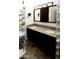 Bright bathroom featuring double vanity with granite countertop and mirrored cabinets at 968 W Breckenridge Ave, Gilbert, AZ 85233