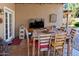 Covered patio with a flat screen TV and seating for eight at 968 W Breckenridge Ave, Gilbert, AZ 85233