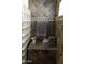 Stylish shower with gray towels, glass blocks, and stone tile walls at 968 W Breckenridge Ave, Gilbert, AZ 85233