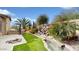 Landscaped backyard oasis with water feature, built-in grill, and fire pit at 11454 N 87Th Pl, Scottsdale, AZ 85260