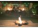 Night view of backyard oasis with fire pit, water feature, and string lights at 11454 N 87Th Pl, Scottsdale, AZ 85260