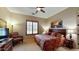 King-size bed in a large bedroom with an armchair and TV at 11454 N 87Th Pl, Scottsdale, AZ 85260