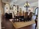 Open-concept dining area with hardwood floors, decorative chandelier, and living room access at 11454 N 87Th Pl, Scottsdale, AZ 85260