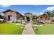 Stunning stone exterior with landscaped front yard and inviting walkway at 11454 N 87Th Pl, Scottsdale, AZ 85260