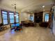 Bright living room featuring large windows and stone fireplace with TV and hardwood style flooring at 11454 N 87Th Pl, Scottsdale, AZ 85260