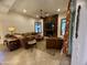 Living room featuring a stone fireplace, television, ceiling fan and comfortable seating area at 11454 N 87Th Pl, Scottsdale, AZ 85260