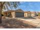 Front view of a charming house with gray garage door and landscaped yard at 1353 E Kelsi Ave, San Tan Valley, AZ 85140