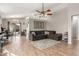 Spacious living room with L-shaped sectional sofa and wood-look floors at 1353 E Kelsi Ave, San Tan Valley, AZ 85140