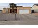 Tan house with a two car garage and palm tree at 1508 E Todd E Dr, Tempe, AZ 85283