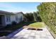 Landscaped backyard with a stone patio and lawn at 1526 W Wilshire Dr, Phoenix, AZ 85007