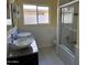 Clean bathroom with double sinks, shower, and bathtub at 1526 W Wilshire Dr, Phoenix, AZ 85007