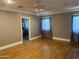 Spacious bedroom with hardwood floors and en-suite bathroom access at 1526 W Wilshire Dr, Phoenix, AZ 85007