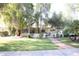 Charming ranch house with a brick walkway and large tree at 1526 W Wilshire Dr, Phoenix, AZ 85007