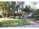 Cute ranch home with brick pathway, lush lawn, and mature trees at 1526 W Wilshire Dr, Phoenix, AZ 85007