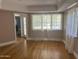 Light-filled living room featuring hardwood floors and large windows at 1526 W Wilshire Dr, Phoenix, AZ 85007