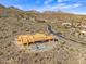 Aerial view of a large house under construction with a pool, in a desert mountain setting at 15728 N Mountain Pkwy, Fountain Hills, AZ 85268