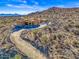 Aerial view of a house under construction with a long driveway and mountain views at 15728 N Mountain Pkwy, Fountain Hills, AZ 85268