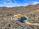 Aerial view of a house under construction with a pool, in a desert mountain setting at 15728 N Mountain Pkwy, Fountain Hills, AZ 85268