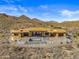 Aerial view of a large house under construction with a pool, in a desert mountain setting at 15728 N Mountain Pkwy, Fountain Hills, AZ 85268