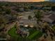 House with backyard oasis, putting green, and a pool; located in a residential community at 15996 W Mesquite Ct, Surprise, AZ 85374