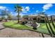 Landscaped backyard with putting green and patio at 15996 W Mesquite Ct, Surprise, AZ 85374