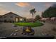 Landscaped backyard with putting green and fire pit at 15996 W Mesquite Ct, Surprise, AZ 85374