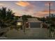 Single-story home with a tile roof, desert landscaping, and a two-car garage at 15996 W Mesquite Ct, Surprise, AZ 85374