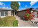 Front entry with red flowers and a walkway to the front door at 15996 W Mesquite Ct, Surprise, AZ 85374