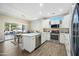 Modern kitchen with white cabinets, stainless steel appliances, and quartz countertops at 15996 W Mesquite Ct, Surprise, AZ 85374