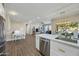 Modern kitchen with white cabinets, stainless steel appliances, and quartz countertops at 15996 W Mesquite Ct, Surprise, AZ 85374