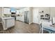 Modern kitchen with white cabinets, stainless steel appliances, and an eat-in area at 15996 W Mesquite Ct, Surprise, AZ 85374