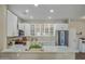 Modern kitchen with white cabinets, stainless steel appliances, and a large island at 15996 W Mesquite Ct, Surprise, AZ 85374