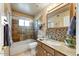 Clean bathroom with a tub shower combo, granite countertop and tile at 19504 N 88Th Dr, Peoria, AZ 85382