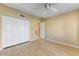 Spacious bedroom with hardwood floors, ceiling fan and large closet at 19504 N 88Th Dr, Peoria, AZ 85382