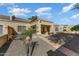 Back exterior view showing covered patio and desert landscaping at 19504 N 88Th Dr, Peoria, AZ 85382