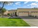 Beautiful desert landscape home with two-car garage and grassy yard at 19504 N 88Th Dr, Peoria, AZ 85382