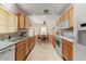 Well-equipped kitchen with light wood cabinets and ample counter space at 19504 N 88Th Dr, Peoria, AZ 85382