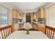 Kitchen features light wood cabinets, tile floors, and breakfast nook at 19504 N 88Th Dr, Peoria, AZ 85382