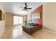 Spacious main bedroom with hardwood floors and ceiling fan at 19504 N 88Th Dr, Peoria, AZ 85382