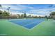 Well-lit tennis courts with green and blue surface at 19504 N 88Th Dr, Peoria, AZ 85382