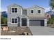 Two-story home with gray exterior, two-car garage, and desert landscaping at 2177 W Stanton Ave, Apache Junction, AZ 85120
