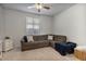 Comfortable living room featuring a sectional sofa and ceiling fan at 22889 E Marsh Rd, Queen Creek, AZ 85142