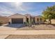 House exterior showcasing a two-car garage and desert landscaping at 2599 E San Mateo Dr, Casa Grande, AZ 85194