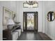 Inviting entryway with ornate iron door, elegant decor, console table, and hardwood floors at 28484 N 91St Ave, Peoria, AZ 85383